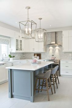 a large kitchen with an island and bar stools