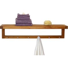 a towel rack with towels on it next to a pile of folded towels and a sponge