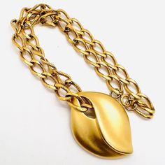 Excellent vintage 80's matte gold tone/plated modernist necklace. Large slide pendant in modernist design on wide thick chain with wide etched links. Pendant measures 2 1/8 inches tall by 1 1/2 inches wide. Chain is 3/8 inch wide and 18 inches long with secure clasp. Excellent vintage condition with minimal age appropriate wearvery minimal. Nice heavier quality necklace. Vintage Designer Jewelry, Modernist Design, Vintage Designer, Matte Gold, Designer Jewelry, Pendant Necklaces, Jewelry Necklace Pendant, Gold Tones, Jewelry Necklaces