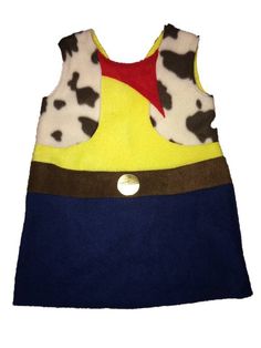 a child's dress made out of fleey material with a cow print on it