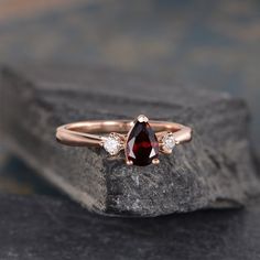 "Three Stone Garnet Engagement Ring Pear Shaped Rose Gold 3 Stone Bridal Diamond Women Anniversary Gift Drop Tear Wedding Rainbow ITEM INFORMATION Metal Type - Solid 14k Rose Gold Band Width - (approx.. 1.5mm) Center Stone - 5*7mm Natural Garnet, Pear Shaped Side Stone - Natural Diamond Weight - 0.12ct Clarity -SI Color - H **Stone Replacement** Available with any other gemstones, please feel free to contact me for a quote. **Metal Type** Available in 14K or 18K yellow gold, white gold, and rose Rose Gold Three Stone Wedding Ring, Wedding Teardrop Three Stone Jewelry, Wedding Teardrop Three-stone Jewelry, Wedding Rainbow, Engagement Ring Pear Shaped, Ring Pear Shaped, Engagement Ring Pear, Garnet Engagement Ring, Pear Shaped Engagement Rings