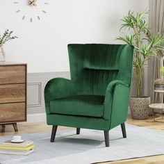 a green chair sitting on top of a rug in front of a wall mounted clock