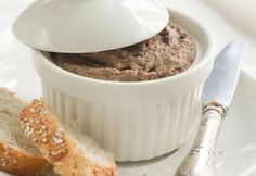 a white bowl filled with food on top of a table