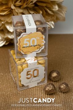 two clear boxes filled with chocolate candies on top of a brown carpeted floor