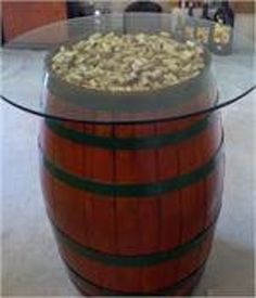 a wooden barrel sitting on top of a glass table