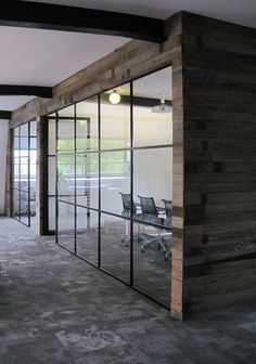 an office with glass walls and wood paneling on the wall is seen in this screenshot