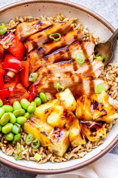 a bowl filled with meat, vegetables and rice