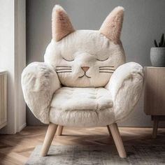 a white cat chair sitting on top of a wooden floor