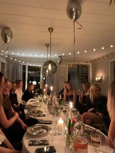 a group of people sitting around a dinner table