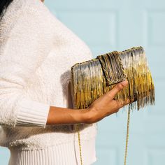 Money back guarantee, if this clutch doesn’t make you dance the shimmy! Seriously! Made of multiple rows of metallic fringe tassels that are crafted by hand to achieve the luxuriously shimmering gradient effect, this labor of love has captured so many hearts since she was launched and is our best selling clutch since 2019! Add her to your cart, you won’t regret it! Composition: Ombre pattern of silver, gold and rose gold metal hanging chains; top flap has the chains braided Lush black velvet int Chain Braid, Ombre Pattern, Braid Designs, Party Clutch, Velvet Interiors, Party Look, Rose Gold Metal, Tassel Fringe, Gorgeous Gowns