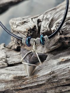 Peace River Find! This Shark Tooth Fossil is wrapped in silver tone wire with shimmering, multi color beads, green and purple. This is a hand sifted Tooth and hand wrapped item, placed on an 18 inch, black, Leather cord with lobster claw clasp. Second one down in the group picture. Thank you for looking! Silver Waxed Cord Necklace For Gift, Silver Hand Wrapped Metal Necklace, Silver Necklace With Waxed Cord For Gift, Nickel-free Waxed Cord Necklace For Gifts, Nickel-free Waxed Cord Necklace - Ideal Gift, Handmade Adjustable Silver-plated Wire Necklace, Handmade Adjustable Silver Plated Wire Necklace, Adjustable Bohemian Necklace In Silver Plated Wire, Hand Wrapped Silver Necklaces For Festivals