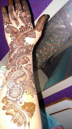 a woman's hand with henna on it