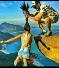 a man helping a woman climb up the side of a cliff with palm trees in her hand