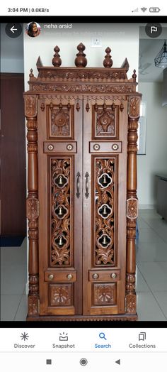 an ornate wooden cabinet with carvings on the front and side doors, is shown in this photo