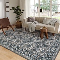 a living room filled with furniture and a large rug