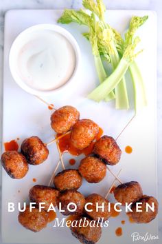 buffalo chicken meatballs on a white plate with celery sticks and ranch dressing