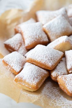 a pile of powdered sugar cookies sitting on top of a table