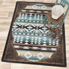 a cowboy hat sitting on top of a chair next to a blue and brown rug