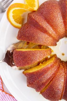 a bundt cake on a plate with orange slices