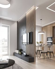 a living room filled with furniture and a flat screen tv on top of a wooden wall