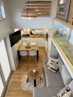 an overhead view of a living room and dining area in a tiny home with wood flooring