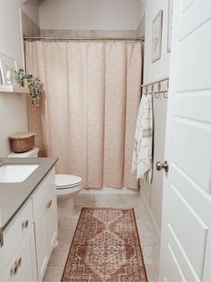 a bathroom with a rug on the floor