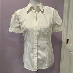 Nwt Vintage 2000s Ann Taylor Loft Petite White Dress Button Down Short Sleeve Shirt In Size 6p. Shot Sleeves Are Pleated, Have Cuffs And Puff Out A Little Which Is Super Cute. I Wish This Still Fit As It’s A Really Classically Tailored Body Conscious Fit In Cotton/Polyester/Spandex Blend Material Which Has Some Stretch. Measurements Are Approximately 16” Across The Chest, 18” Across The Waist, 25” From Top Of Shoulder To Bottom Of The Shirt, 13” From Shoulder Seam To Seam, 9” Sleeves And 6” Cuff Classic Fitted Blouse With Button Closure, Fitted Classic Blouse With Covered Buttons, Fitted Button-up Shirt With Buttons, Classic Fitted Shirt With Back Button Closure, Fitted Office Shirt With Buttons, Fitted Collared Shirt With Buttons, Fitted Button-up Shirt With Button Closure, Fitted Blouse With Buttons For Business Casual, Collared Fitted Blouse With Placket