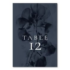 a table number with flowers on it and the numbers 12 - 22 in white lettering