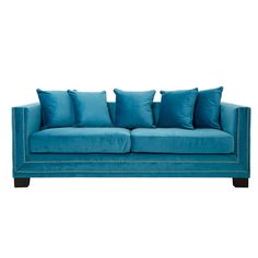 a blue couch with four pillows on it