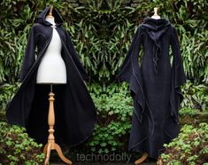 ~ Haunted Hawtin Cloak ~ Made to Measure ~ The floor length Haunted Hawtin Cloak is a simple & beautiful design. Made using soft fleece fabric with elegant trim detail to create a delicate flowing line of colour & form. It is floor length with large medieval flared sleeves, a open front with a single clasp fastening at the throat & pixie hood. *From Petite Pixies to Rubenesque Goddesses.  Whatever shape you take I can accommodate* COLOURS ~ If none of the colours offered tickles your fancy, plea Black Witchy Outerwear For Cosplay, Black Fantasy Style Long Sleeve Outerwear, Black Hooded Medieval Outerwear, Black Fantasy Outerwear For Winter, Black Fantasy Style Winter Outerwear, Fitted Black Fantasy Outerwear, Black Long Sleeve Witchy Outerwear, Royal Cloak, Faerie Clothes