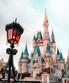 a street light in front of a castle