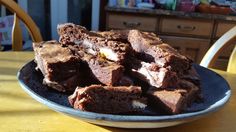 a plate full of brownies sitting on top of a table