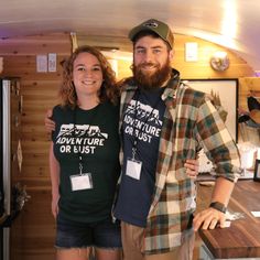 a man and woman standing next to each other in front of a kitchen counter top