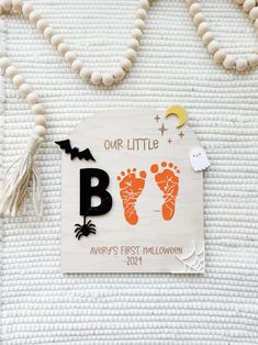 Baby's first Halloween sign This sign is made with 1/8" thick natural maple wood, layered with the cutest acrylic toppers engraved working- will never fade, chip, or peel off  Sign options- comes with or without a Backstand. You must select your choice. Backstand added means that the sign will be able to stand alone. No Backstand means that you will receive just the sign and it will need to lean against an object or wall in order to stay standing.  I recommend using acrylic paint- painting the f Halloween Baby Footprint Art, Boo Halloween Sign, Boo Sign, Halloween Sign, Baby Footprints, Fathers Day Crafts, Baby Memories