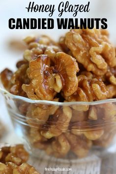 honey glazed candied walnuts in a glass bowl with the words, honey glazed candied walnuts