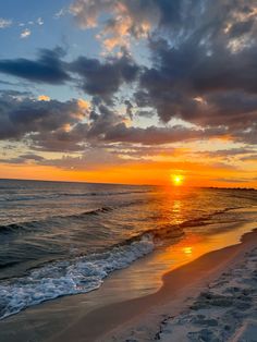 the sun is setting over the water at the beach