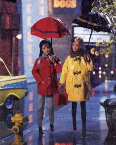 two dolls are walking in the rain with umbrellas