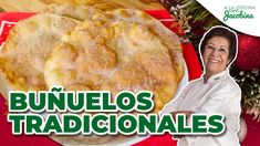 a woman standing in front of a plate with food on it and the words bunuelos tradicionales