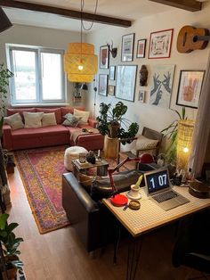 a living room filled with furniture and lots of pictures hanging on the wall above it