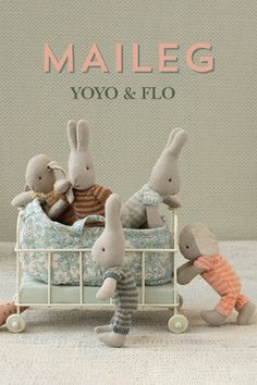 three stuffed animals sitting on top of a bed next to the words maileg yoyo & fio