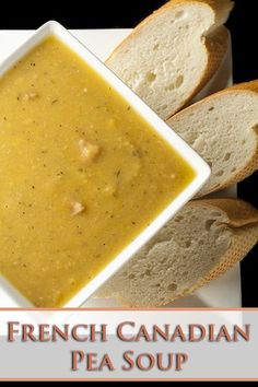 french canadian pea soup in a white bowl with two pieces of bread on the side