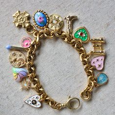 Each Antiqued Gold Charm bracelet is completely unique and handmade in our Texas studio. The one shown in the pictures is the one that you will receive. The chain is made of solid brass with an antique gold wash finish. It’s loaded with a mix of antique gold washed pewter, repurposed vintage and gold filled charms. The mix is the most fun part of making these- we love to mix charms that look vintage with enamel charms, lockets, gemstones and sparkle. Length: 7 1/4 inches Cosmic Jewelry, Gold Wash, Enamel Charms, Look Vintage, Dainty Necklace