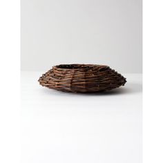 a brown basket sitting on top of a white table