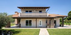 a white house with an open porch and balcony