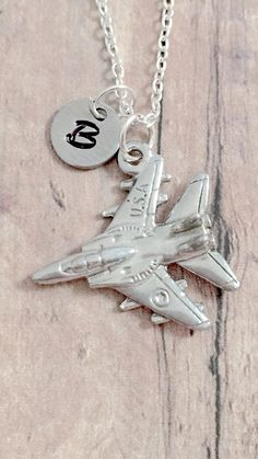 "This listing is for a hand stamped initial necklace featuring a 4/5\" x 4/5\" pewter fighter jet charm & 3/10\" stainless steel initial pendant. The silver plated chain is 18\" long, but can be made to your desired length- see last photo in listing. Please indicate the chain length you would like in the 'notes to seller' section at checkout. All items are lead & nickel free. Message me with any questions, thank you! Add an initial to any necklace https://www.etsy.com/listing/170461597/a Plane Jewelry, Aviation Jewelry, Plane Gifts, Military Jewelry, Poppy Necklace, Tyler Tx, Nature Necklace, Dec 1, Birthstone Charms