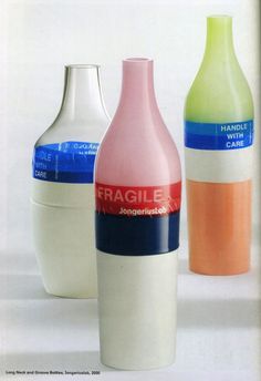 three different colored bottles sitting next to each other