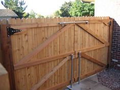 a wooden gate with metal bars on it