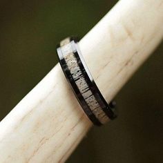 a wooden ring with black and white wood inlayed to it's surface