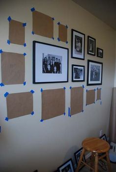 the wall is covered in pictures and taped with blue tape