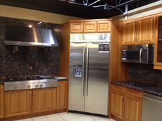 a kitchen with stainless steel appliances and wooden cabinets